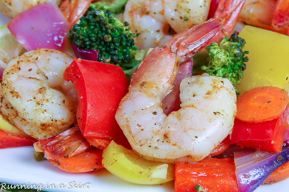 Closeup of cooked shrimp on a white plate.