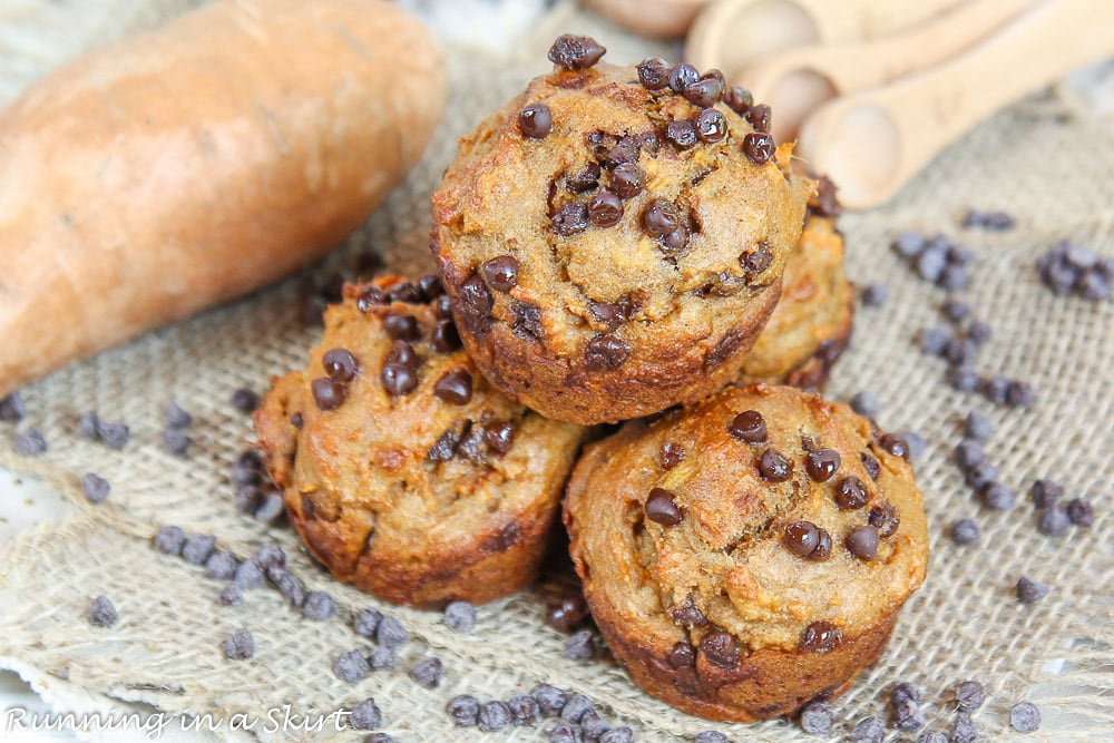 Sweet Potato Muffins stacked together with sweet potatoes in the background.