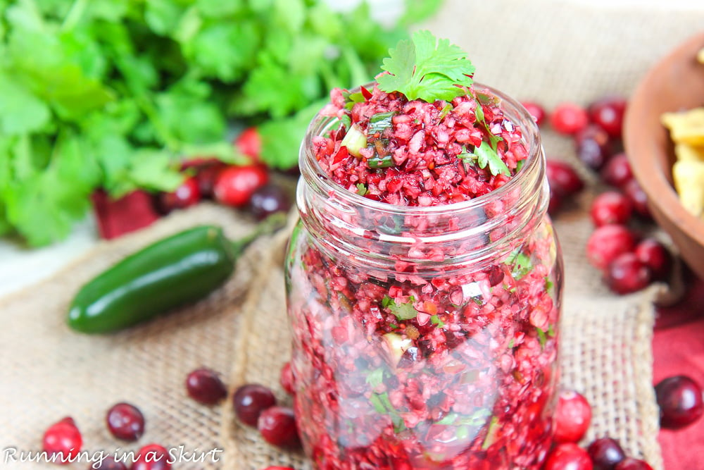 Fresh Cranberry Salsa recipe in a jar with cilantro on top.