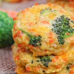 Closeup of broccoli quinoa patties with cheese and carrots.