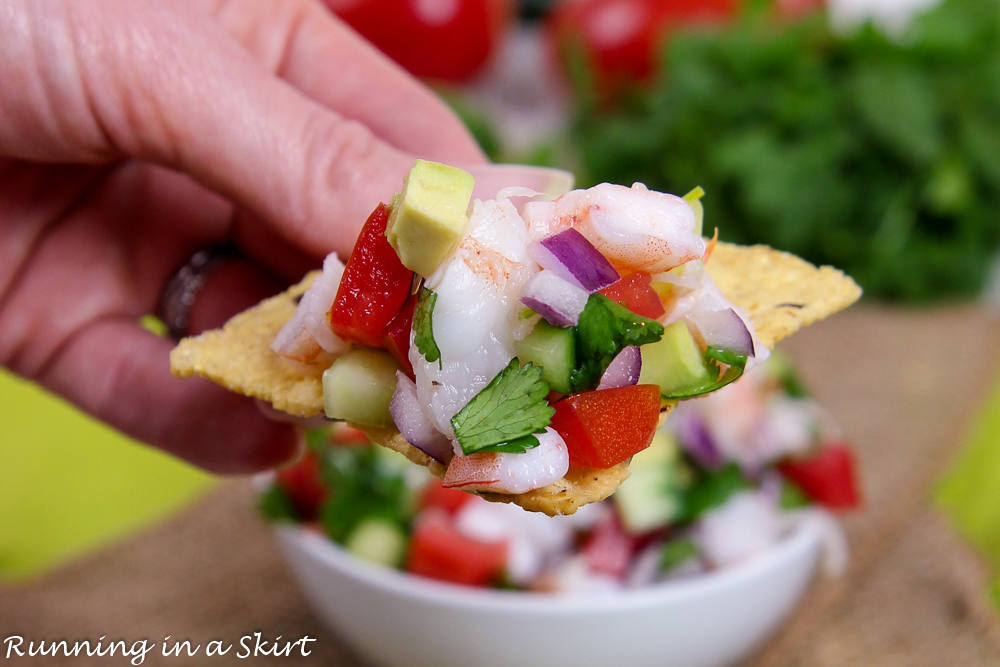 Seafood Salsa recipe on a chip with a hand.