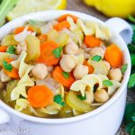 Closeup of soup with chickpeas, carrots, celery, onions and garlic.