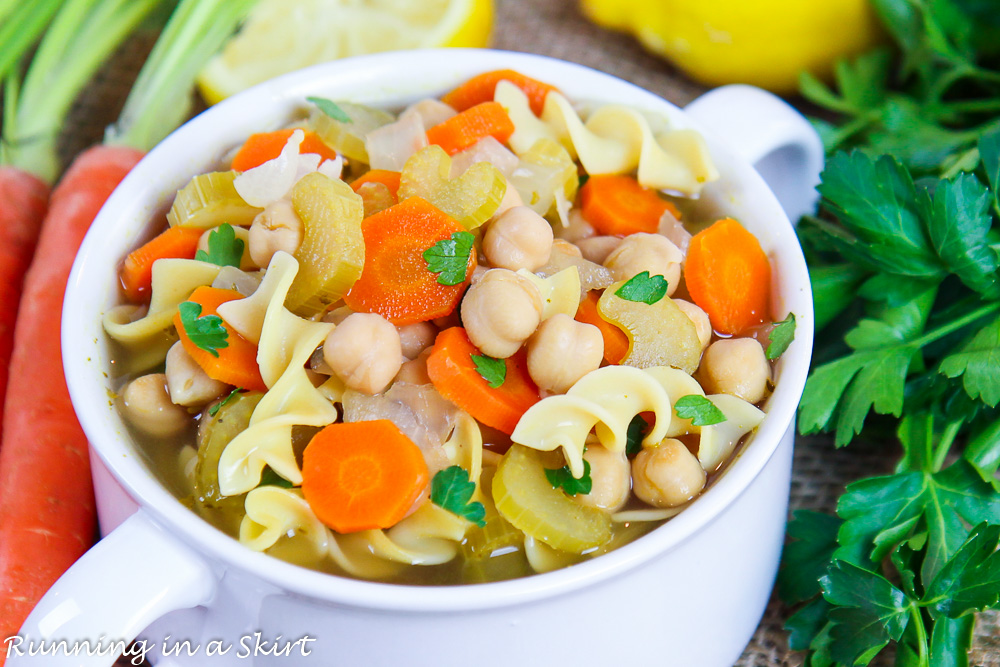 Closeup of soup with chickpeas, carrots, celery, onions and garlic.