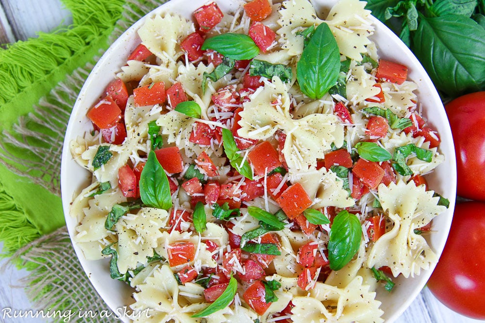 Overhead shot of Bruschetta Pasta Salad recipe in a flat white bowl.