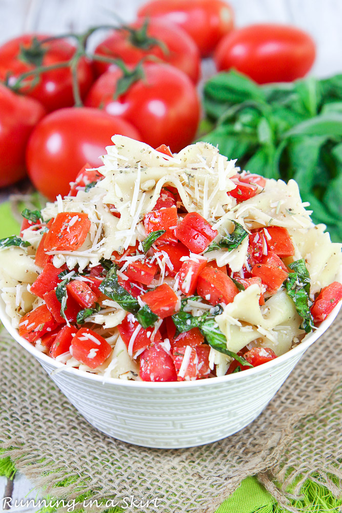 Bruschetta Pasta Salad recipe in a bowl with tomato and basil.