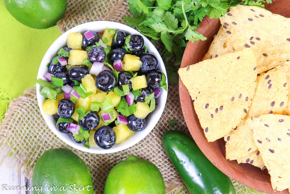 Overhead shot of Blueberry Salsa and chips in a wooden bowl.