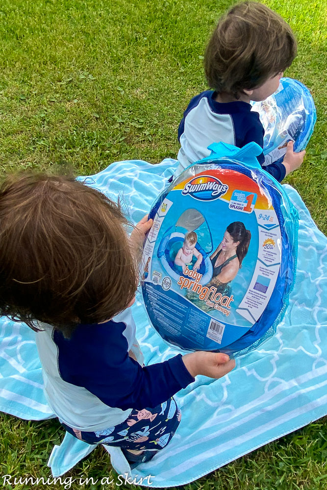 Twin toddlers holding SwimWays Toddler Spring Floats