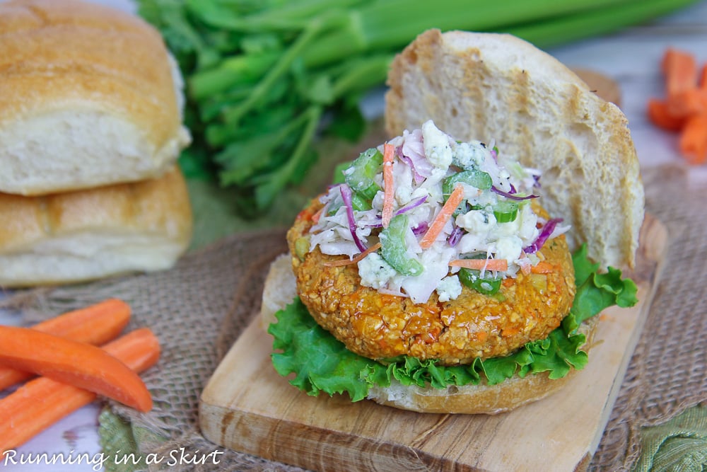 Buffalo Chickpea Burger recipe with Blue Cheese coleslaw on top of a wooden cutting board.