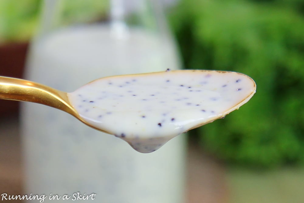 Gold spoon holding healthy poppyseed salad dressing.