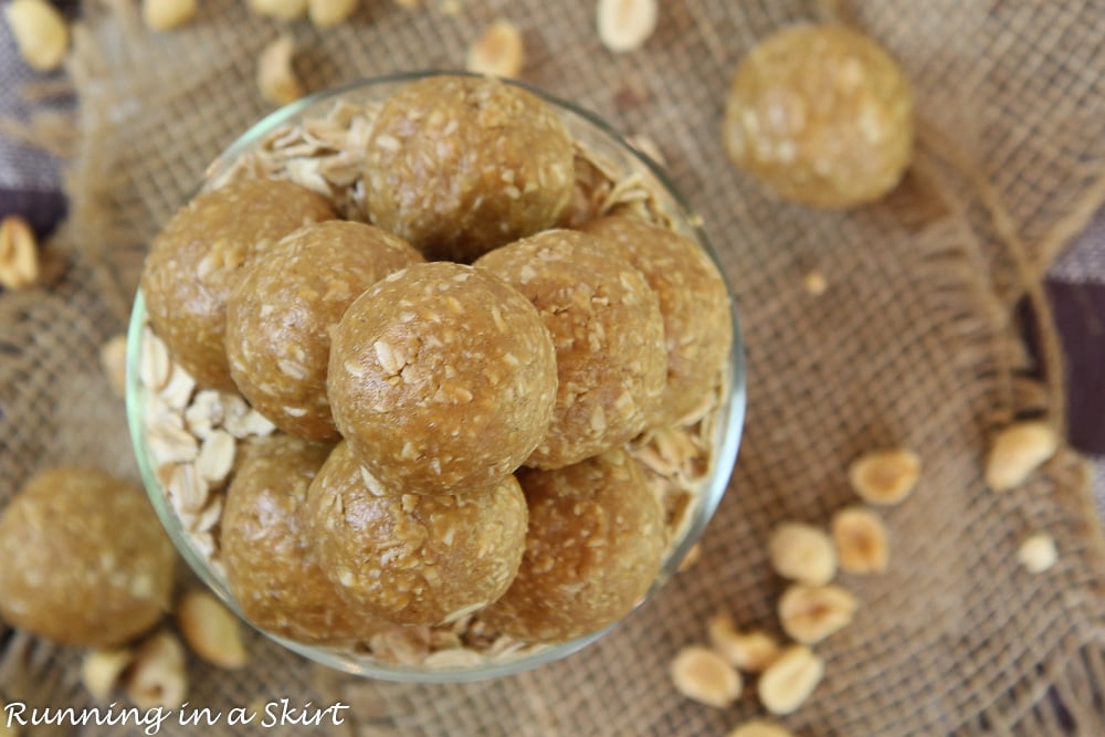 Overhead shot of the 3 Ingredient Peanut Butter Oatmeal Balls in a glass jar with peanuts on the side.