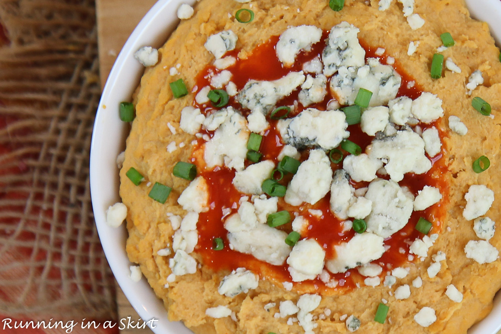 Homemade Buffalo Hummus recipe on a cutting board.