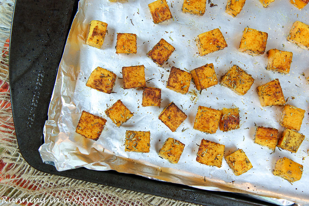 Butternut squash on a pan roasting.