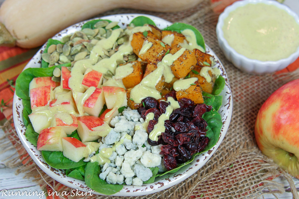 Salad in a bowl with apples, butternut squash and pumpkin seeds.