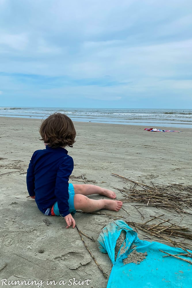 Toddler sitting in sand on Kiawah Island beaches.