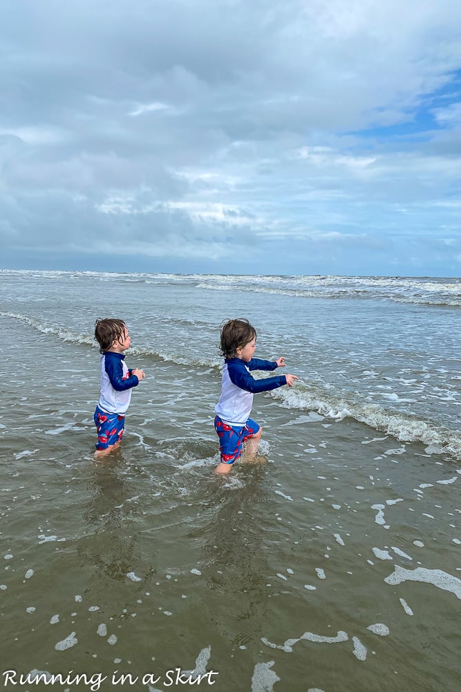 Toddlers running into water on beach Kiawah Island South Carolina