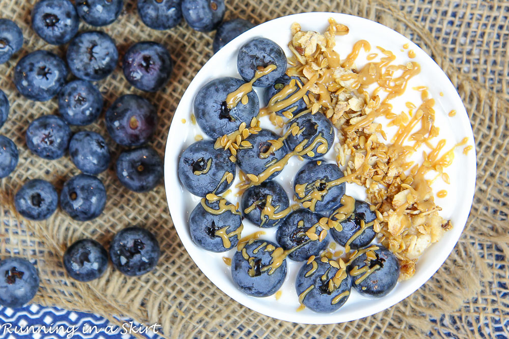 Blueberry Pie Greek Yogurt Bowl on a napkin with extra blueberries.