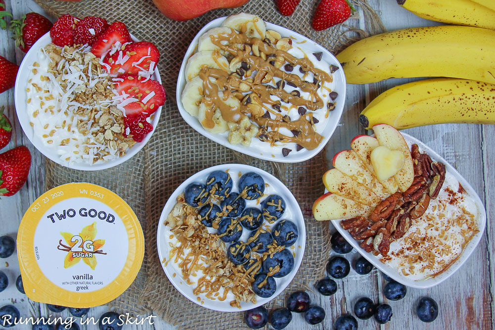 Greek yogurt bowl ideas with four greek yogurt bowls on a napkin with fruit.