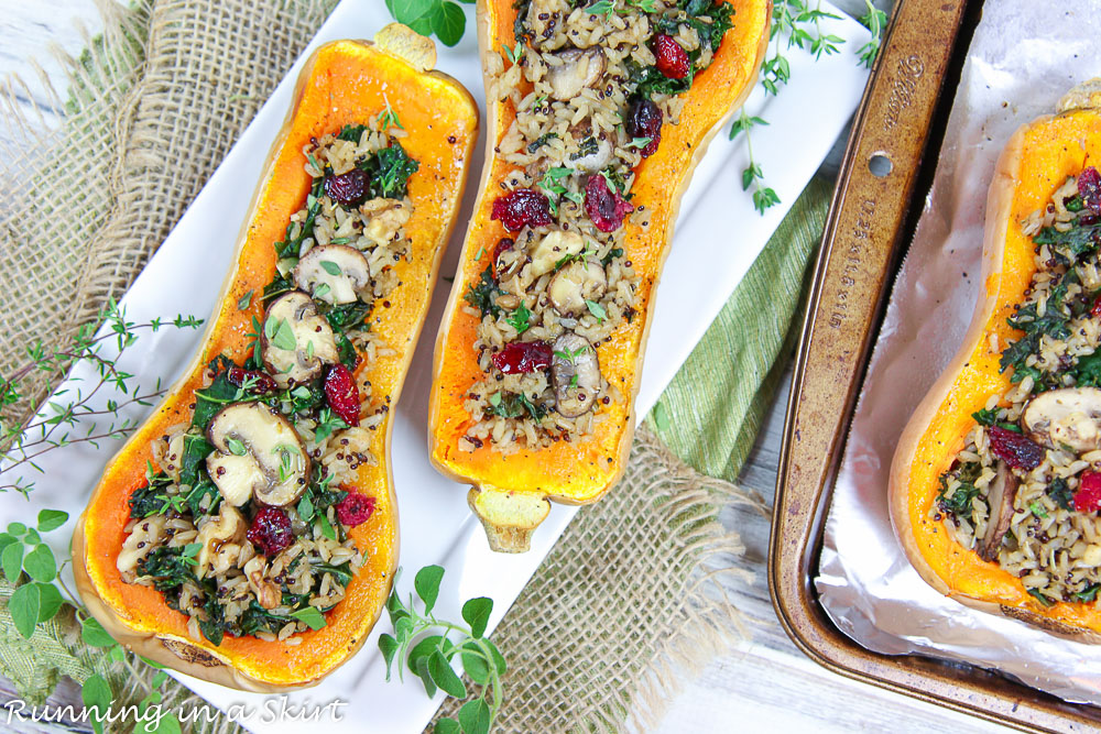 Finished product Vegan Stuffed Butternut Squash on a white plate with herbs.