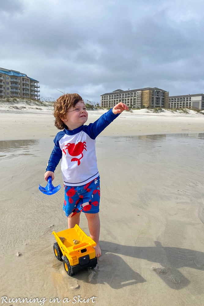 Toddler with a truck on Amelia Island beach.