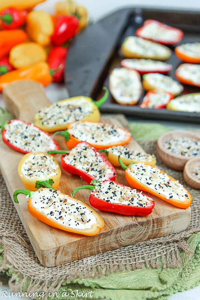 Mini bell peppers on a wooden cutting board and baking tray.