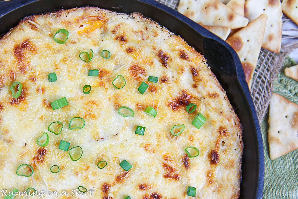 Overhead shot of crab dip in a cast iron skillet.