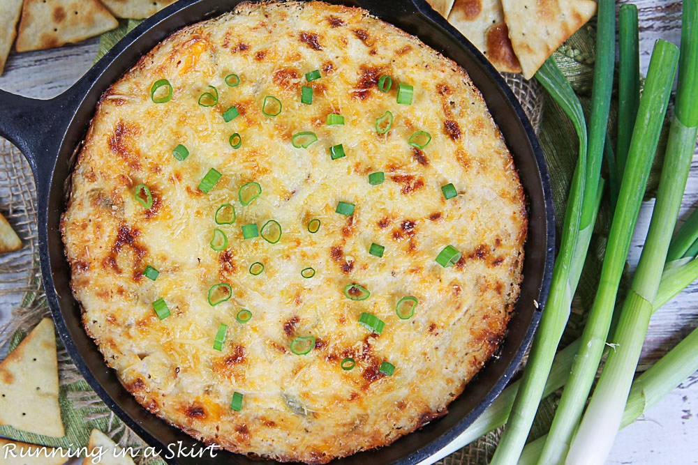 Overhead shot of crab dip and green onions as a garnish.