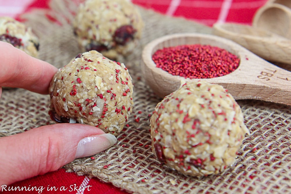 Hand holding Cranberry Oatmeal Energy Bites on a napkin.