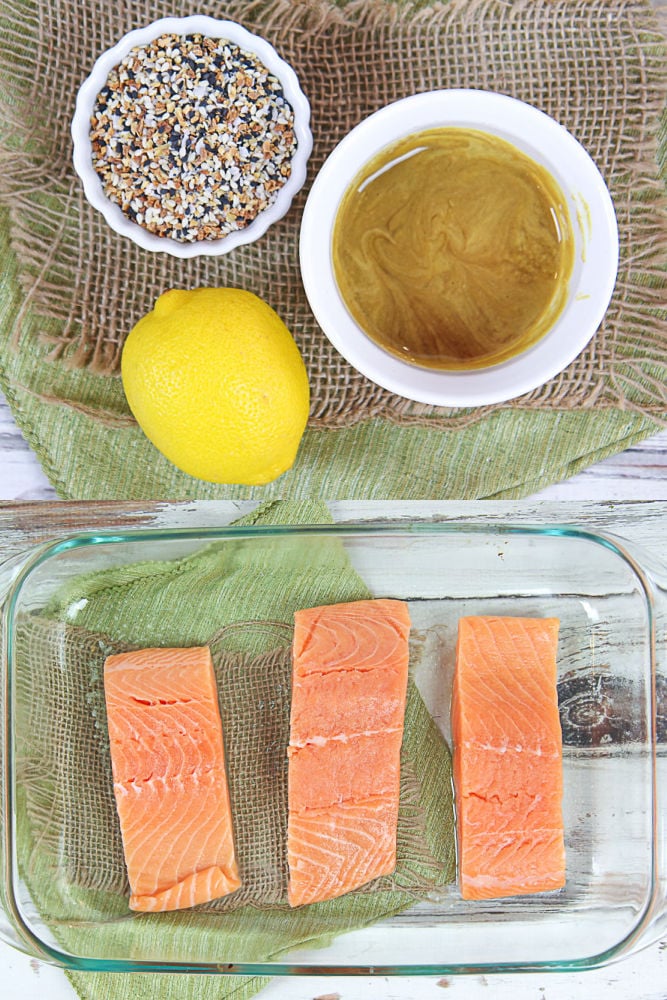 Collage with the ingredients for the recipe - everything bagel seasoning, honey, mustard, lemon and salmon.