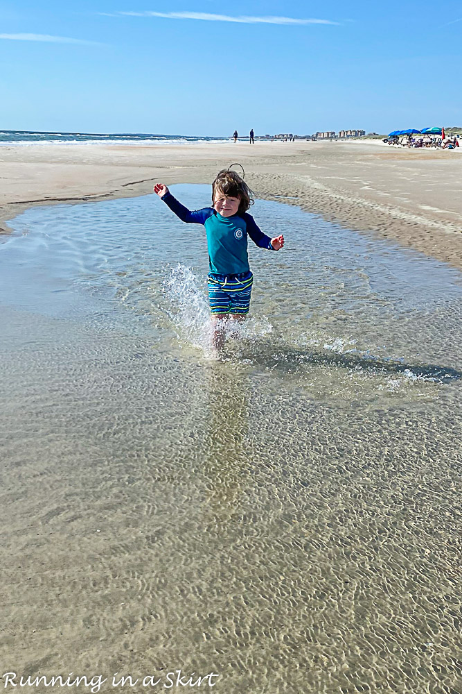 Boy playing in a tidepool.