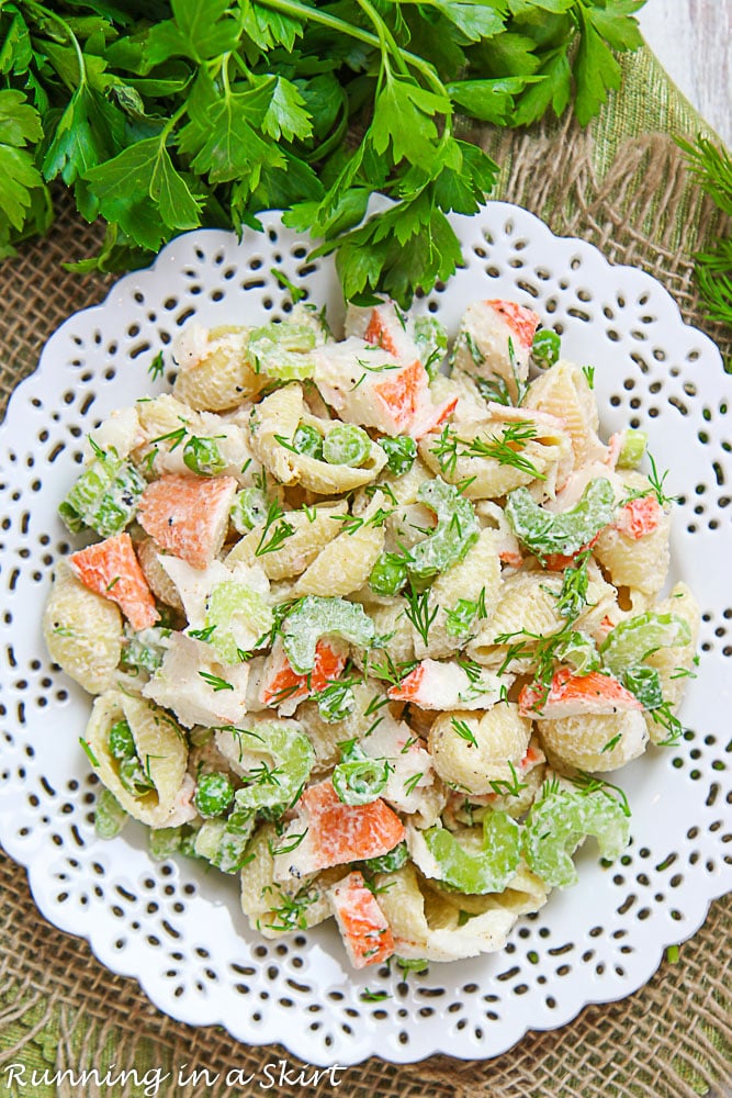 Crab Pasta Salad on a white plate with parsley.