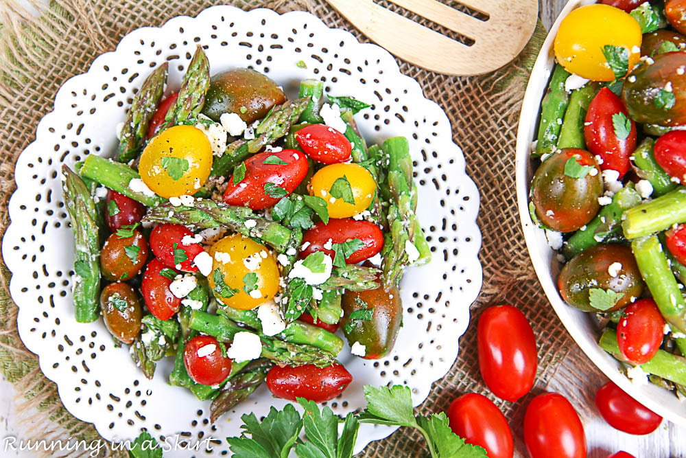 Single serving of the Asparagus and Tomato Salad with a serving bowl to the side.