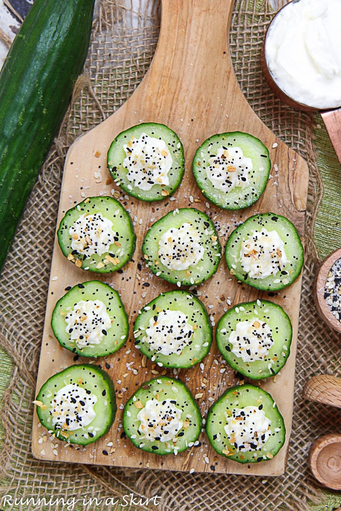 Overhead shot of the cucumber bites on a wooden cutting board.