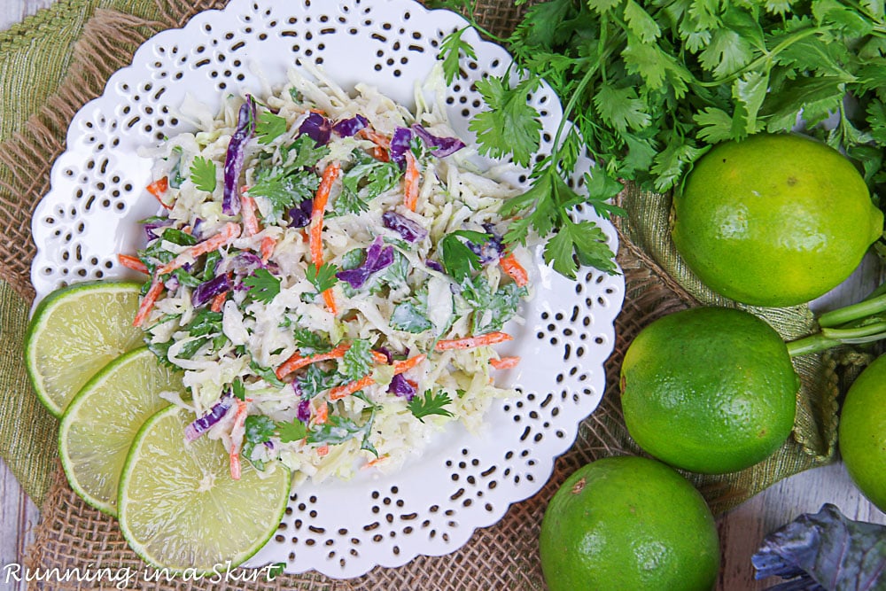 Overhead shot of Cilantro Lime Slaw with limes and cabbage.