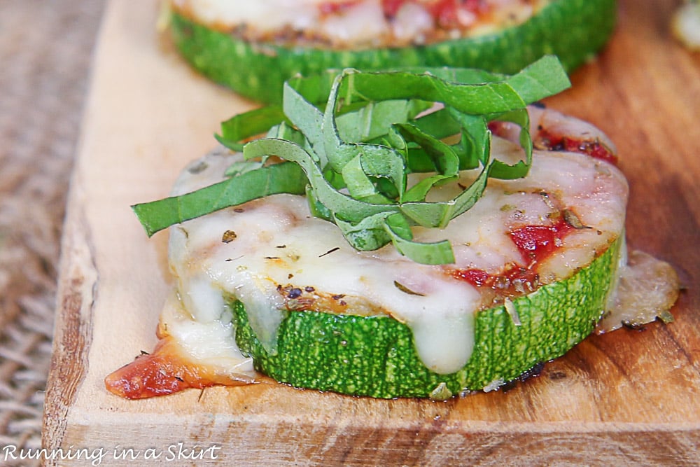 Close up of zucchini pizza bites with basil on top.