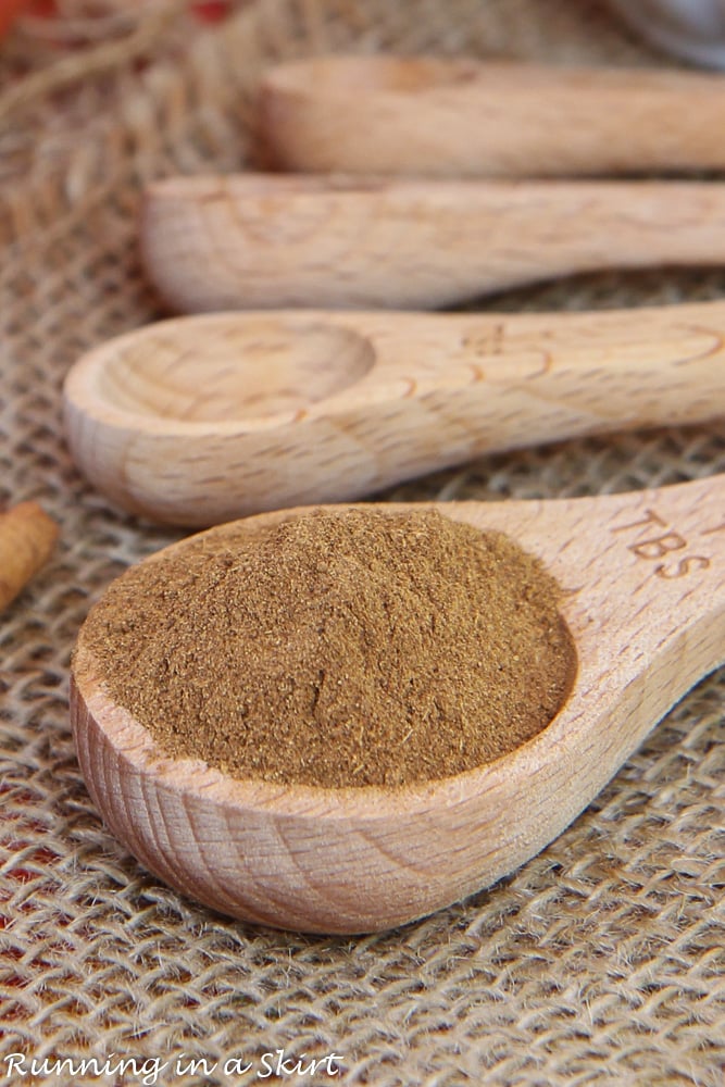 Homemade Pumpkin Pie Spice Recipe in a measuring spoon with a cinnamon stick.