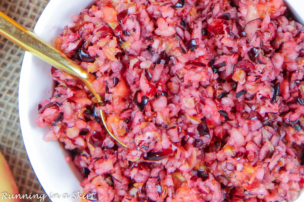 Cranberry Orange Relish in a bowl with gold spoon.