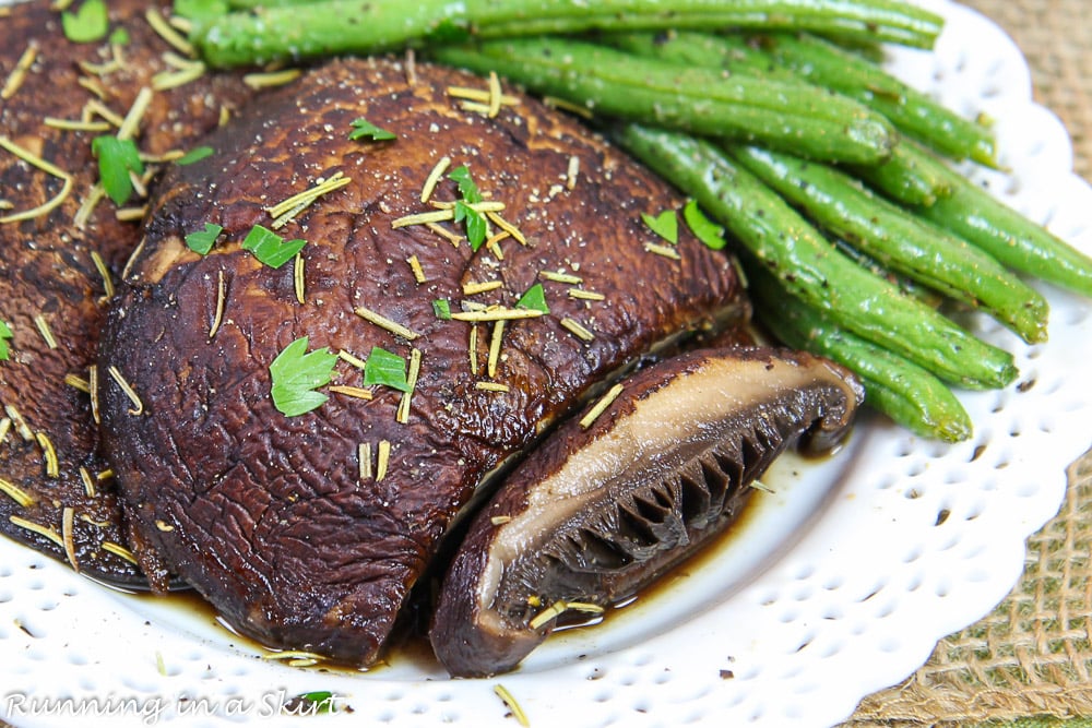 Portobello Mushroom Steak on a white plate with slice cut out.