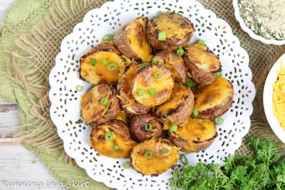 Overhead shot of cheesy ranch potatoes on a white plate.