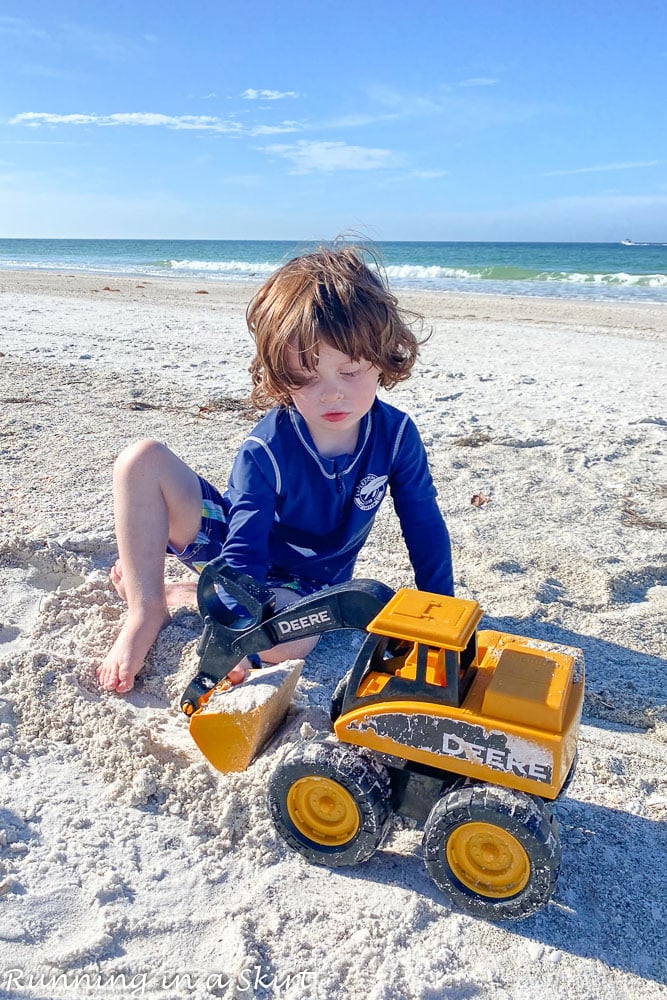 Toddler playing in white sand on Anna Maria Island