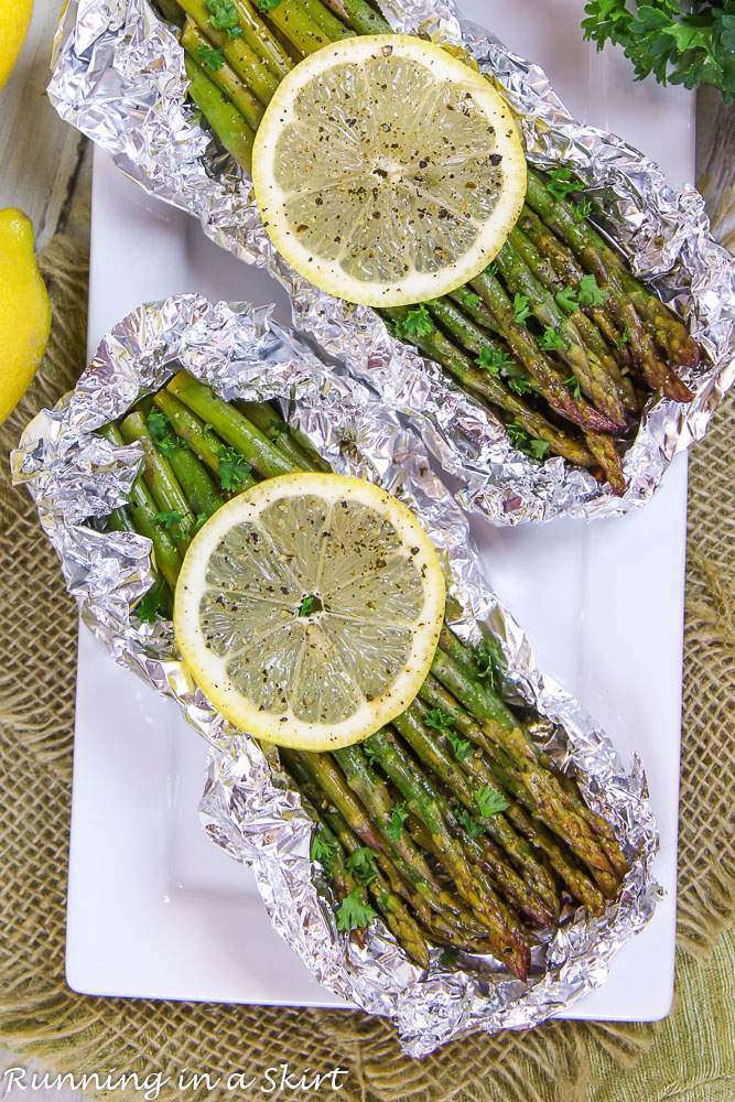Overhead shot of Grilled Asparagus in Foil on white plate.