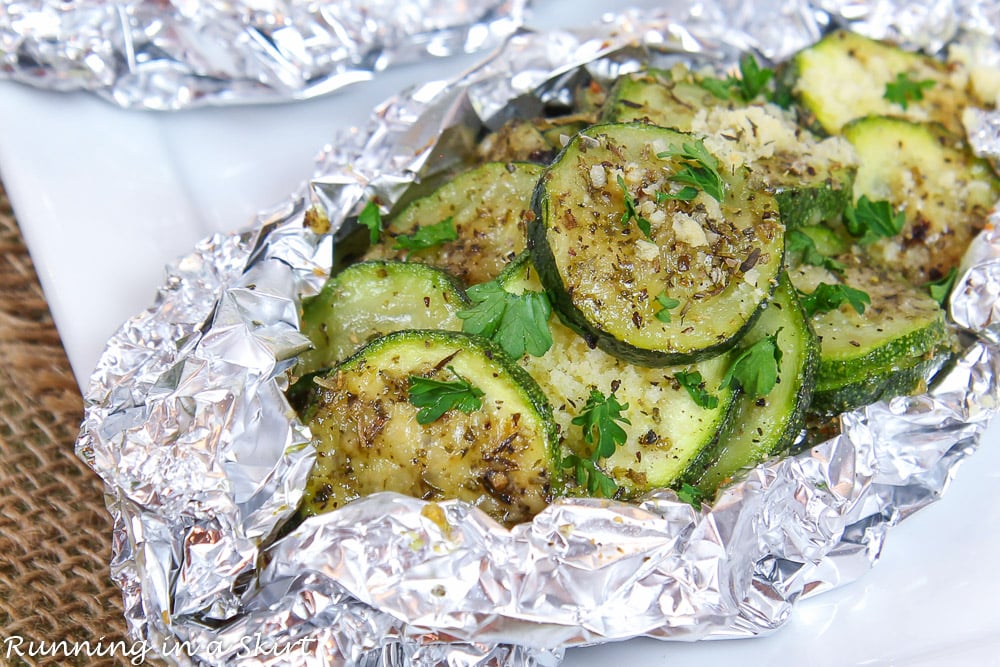 Close up of Zucchini on the Grill in Foil on a white plate.