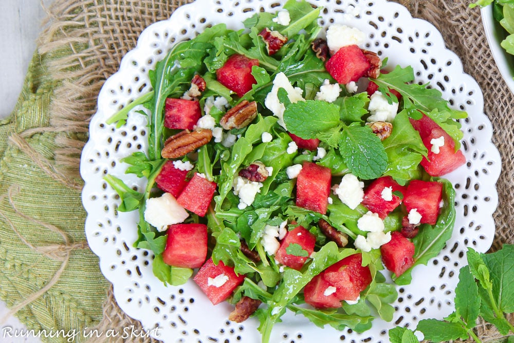 Watermelon Arugula Salad on a white plate overhead shot.