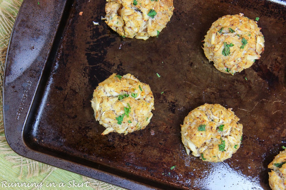 Broiled crab cakes on a baking sheet after broiling them.