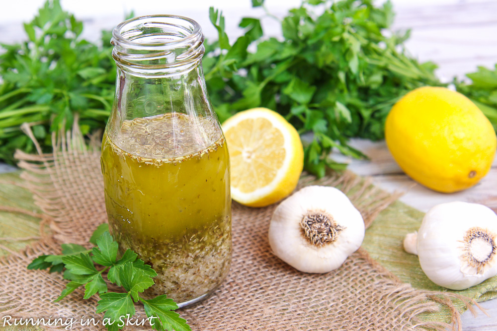 Zesty Italian Dressing with parsley and ingredients surrounding it.
