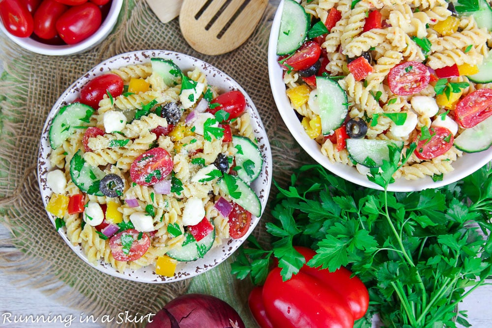 Overhead shot of Zesty Italian Pasta Salad in a regular and serving bowl.