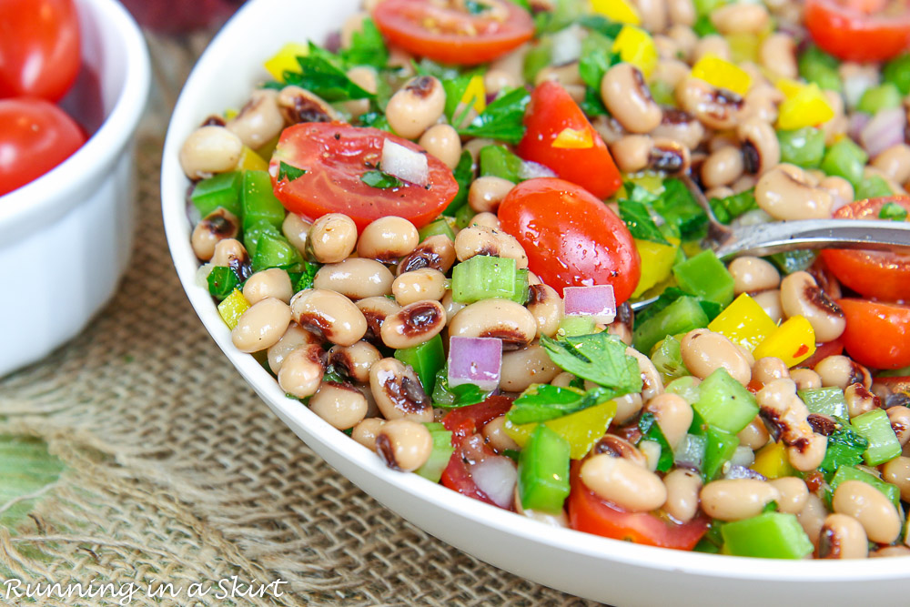 Black Eyed Pea Salad with Italian Dressing in a serving bowl with a spoon.