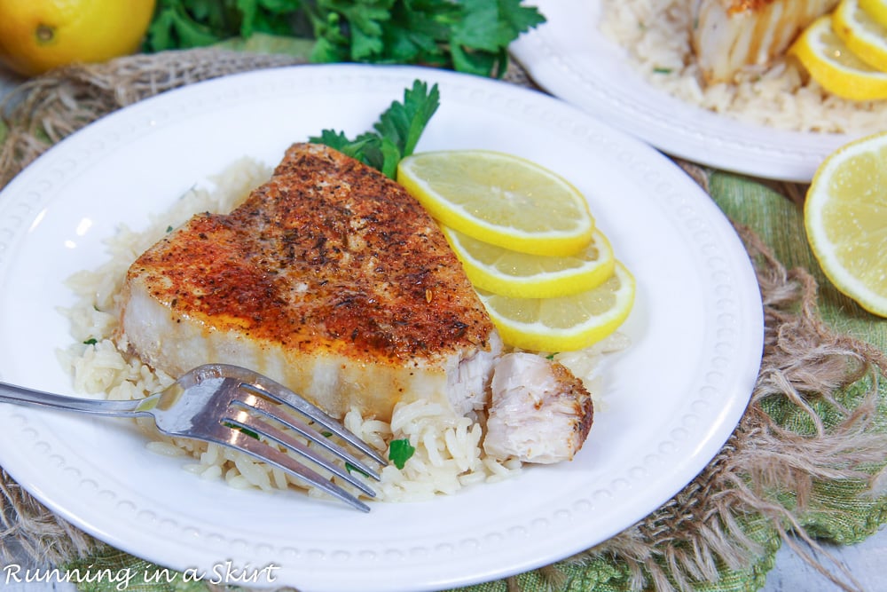 Blackened swordfish with bite taken off by a fork.