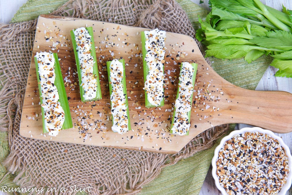 Overhead shot of the Everything Bagel Stuffed Celery Snacks on a wooden cutting board.