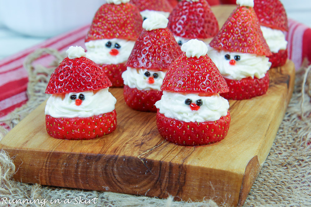 Strawberry Santas with healthy cheescake filling on a wooden plate.