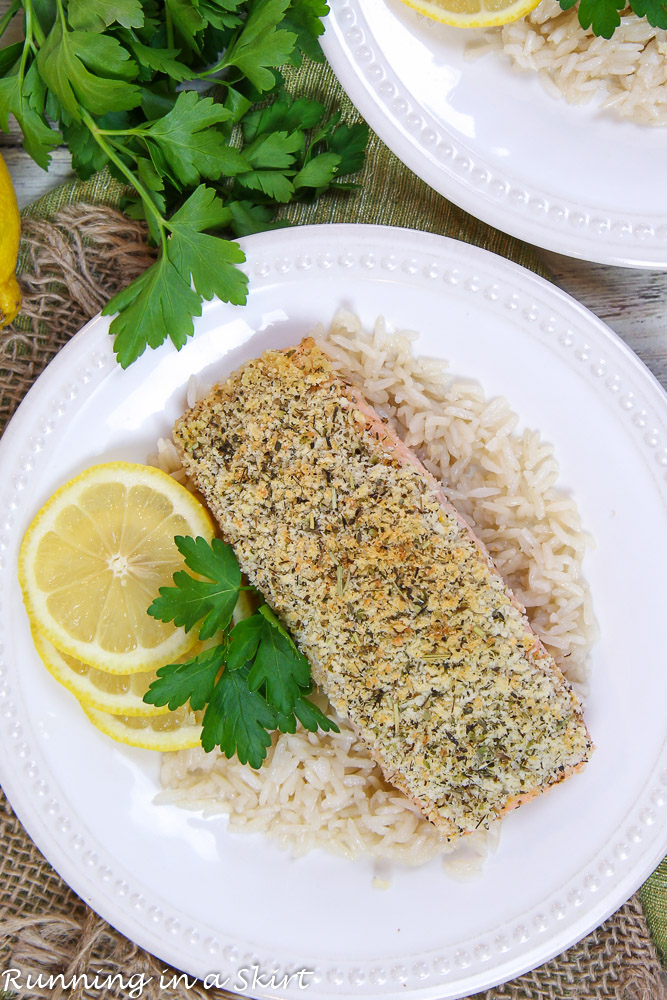 Parmesan Panko Crusted Salmon on a white plate with lemon and parsley.